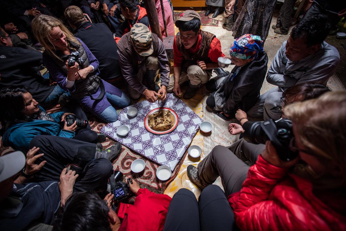A typical dinner setup. Everyone sits on the ground around a bowl of meat. The fat from the sheep’s back is considered a delicacy and is offered to the guests first.