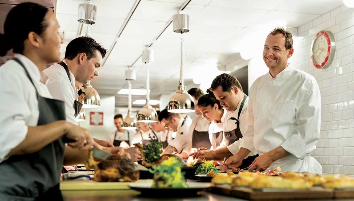Executive head chef, Daniel Humm, talking with his team of chefs in his kitchen at Eleven Madison Park Restaurant, NYC