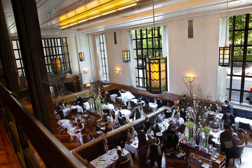 Inside aerial view of Eleven Madison Park restaurant in service, full of patrons and wait staff