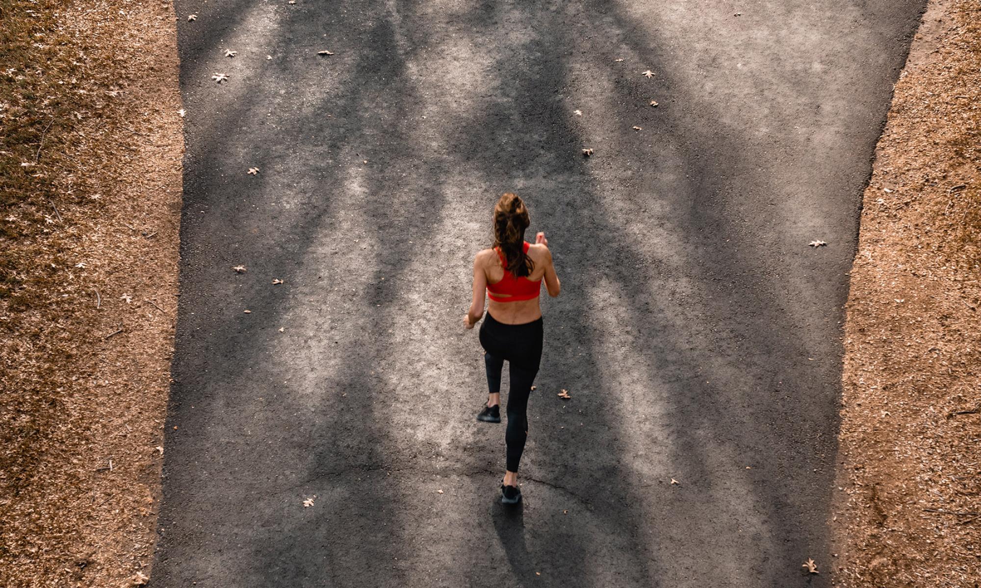 Aerial shot of girl in red top running