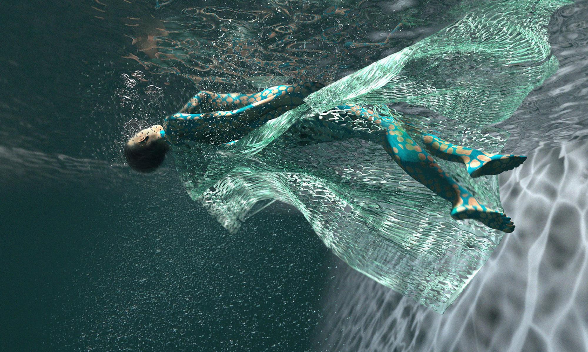 woman wearing a dress made of the ori seri textile floating underwater